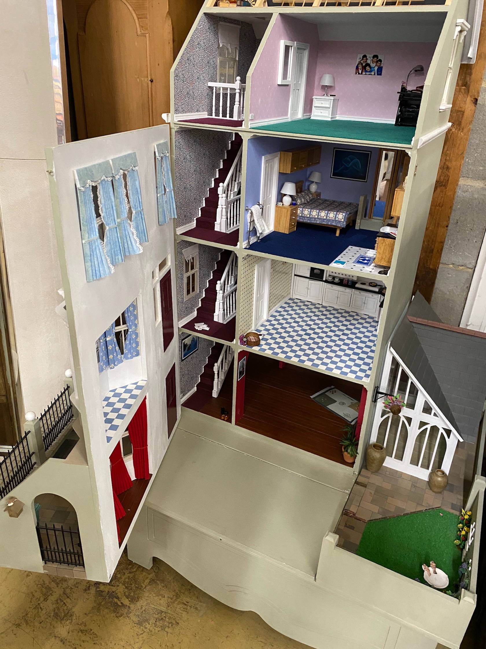 A good quality modern painted wood doll's house, modelled as a Victorian four storey villa, width 76cm, depth 73cm, height 150cm